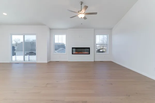 a view of a livingroom with a ceiling fan and window