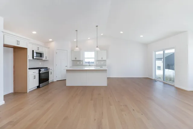 a view of kitchen with wooden floor and windows