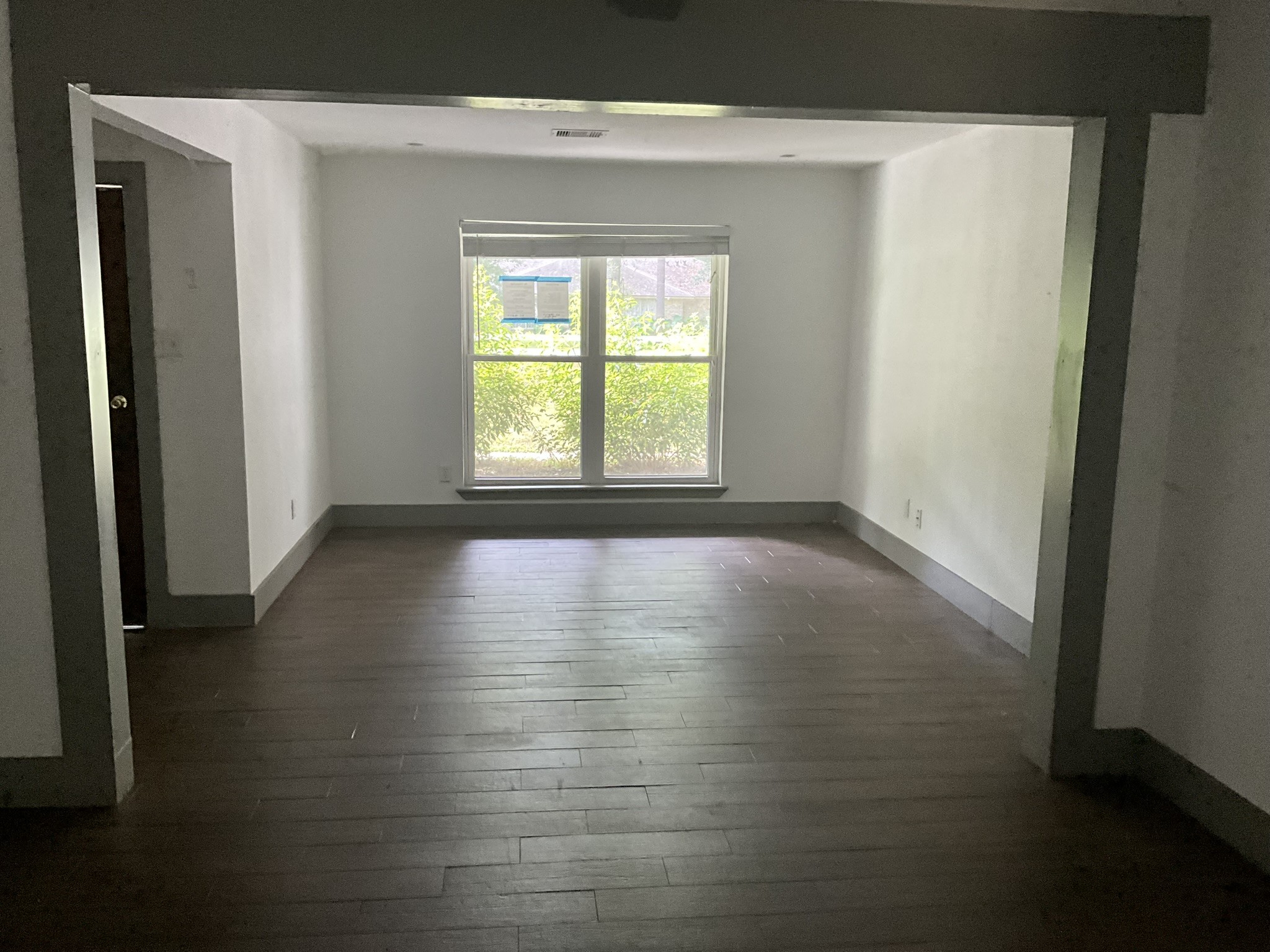 2314 Creekleaf Road Houston, TX 77068 - Photo 4 of 12 Bright dining room with large window and dark flooring, offering a cozy and inviting space.