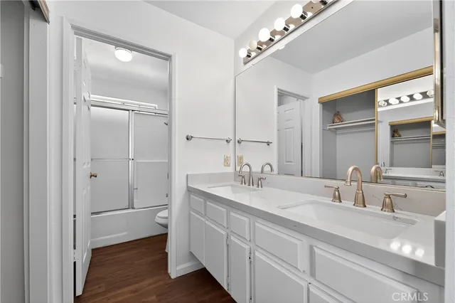a bathroom with a double vanity sink and mirror