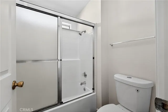 a bathroom with a shower a toilet and a sink