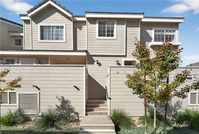 a front view of a house with plants