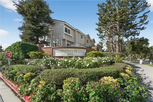 a view of sign board with large trees
