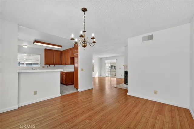 a view of a kitchen with a sink and dishwasher with wooden floor