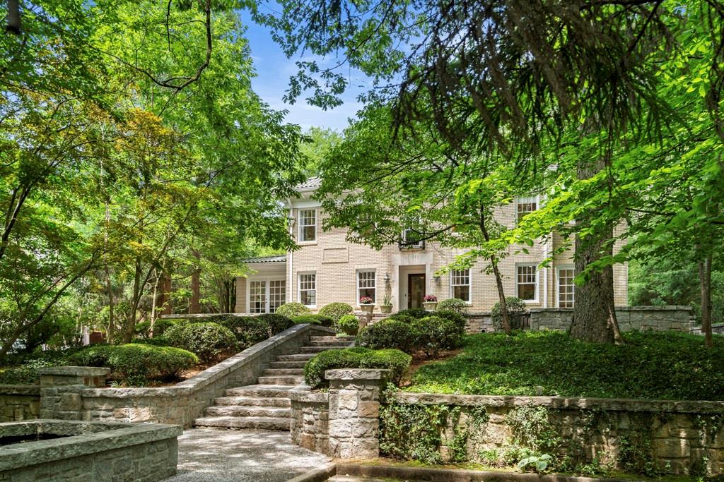 a front view of a house with garden