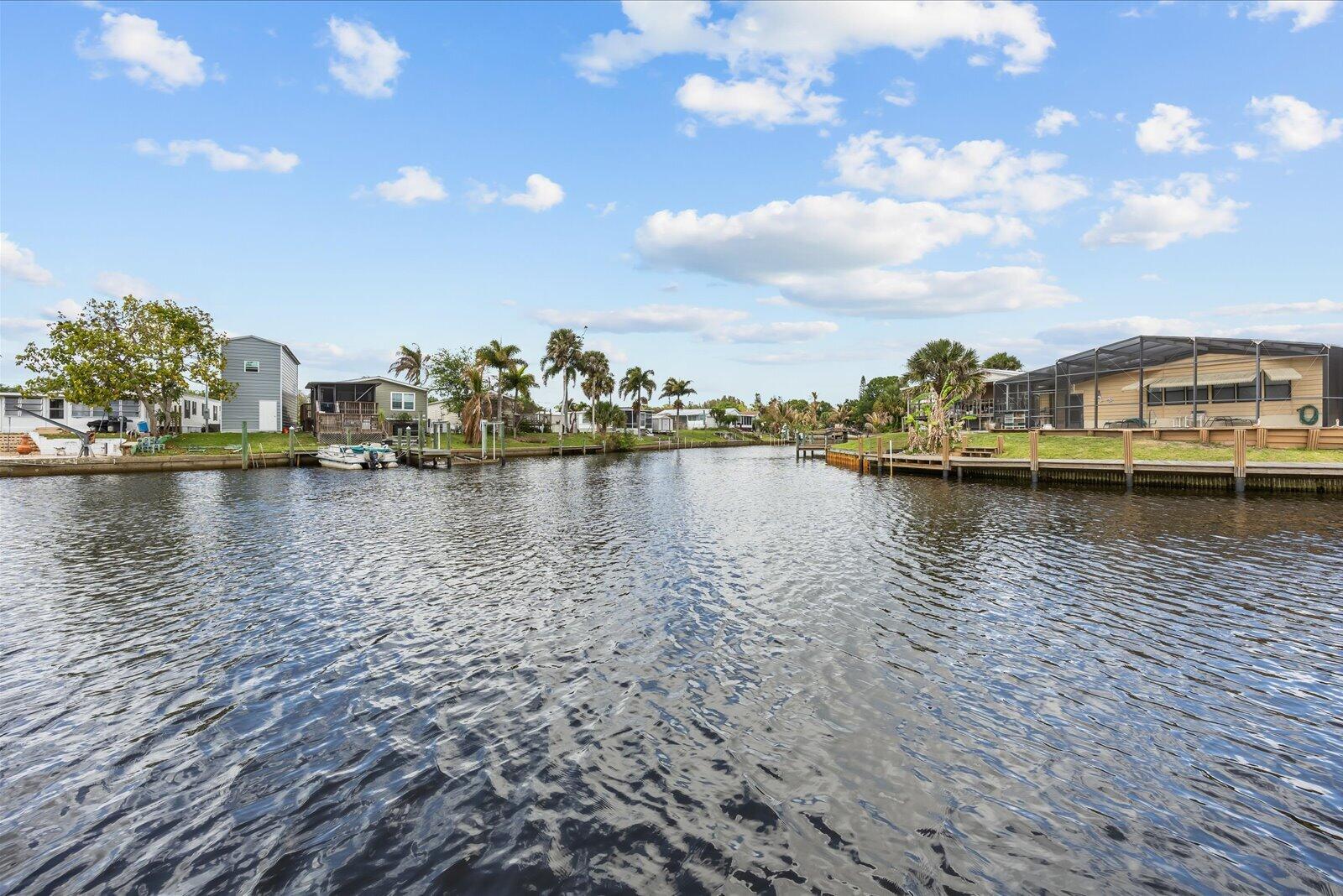 121 Southeast Paradise Place Stuart, FL 34997 - Photo 20 of 33 a view of a lake with boats and trees in the background