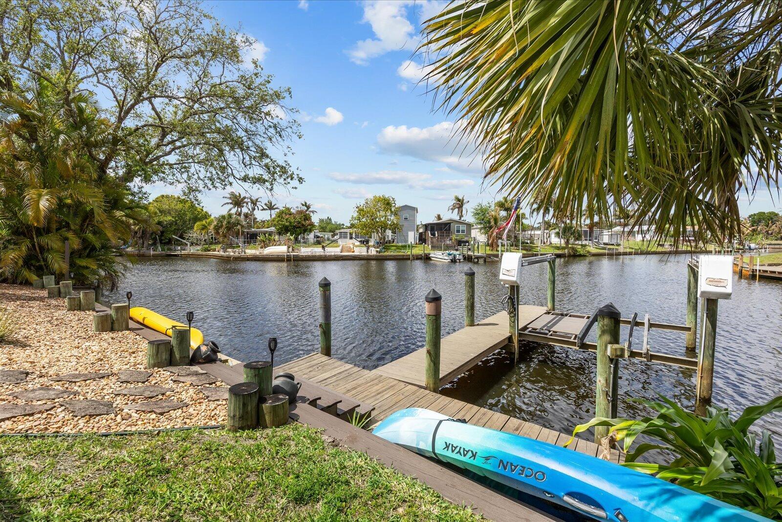 121 Southeast Paradise Place Stuart, FL 34997 - Photo 26 of 33 a view of a lake with chairs