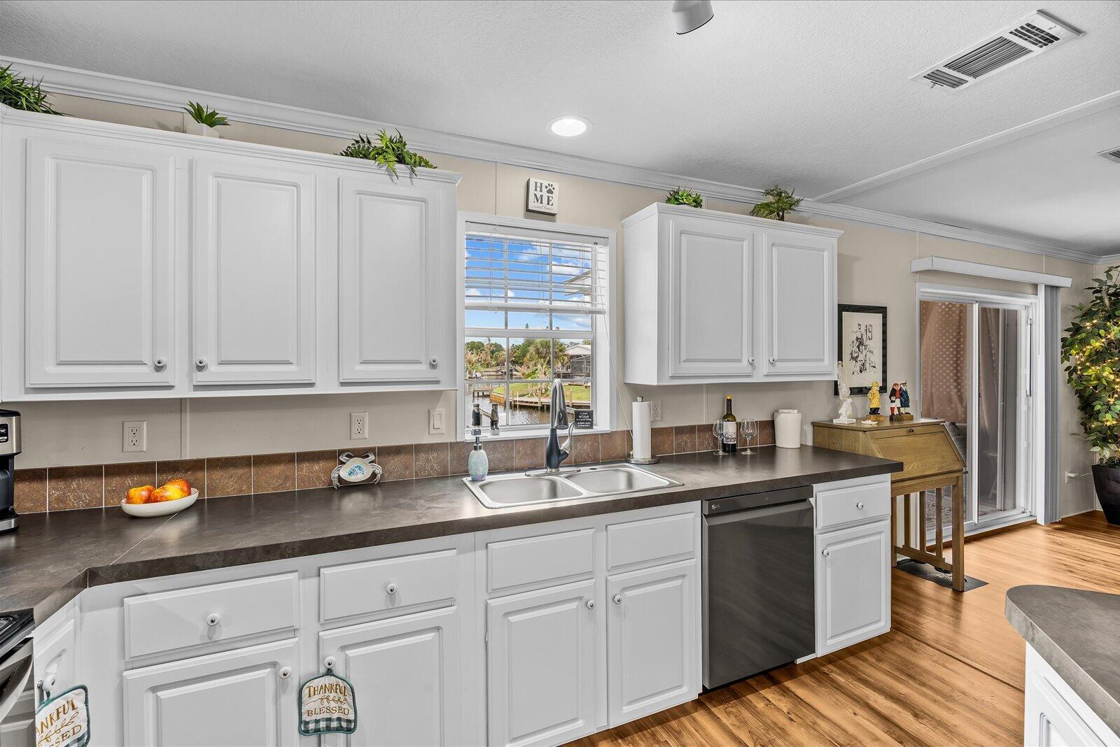 121 Southeast Paradise Place Stuart, FL 34997 - Photo 5 of 33 a kitchen with sink cabinets and window