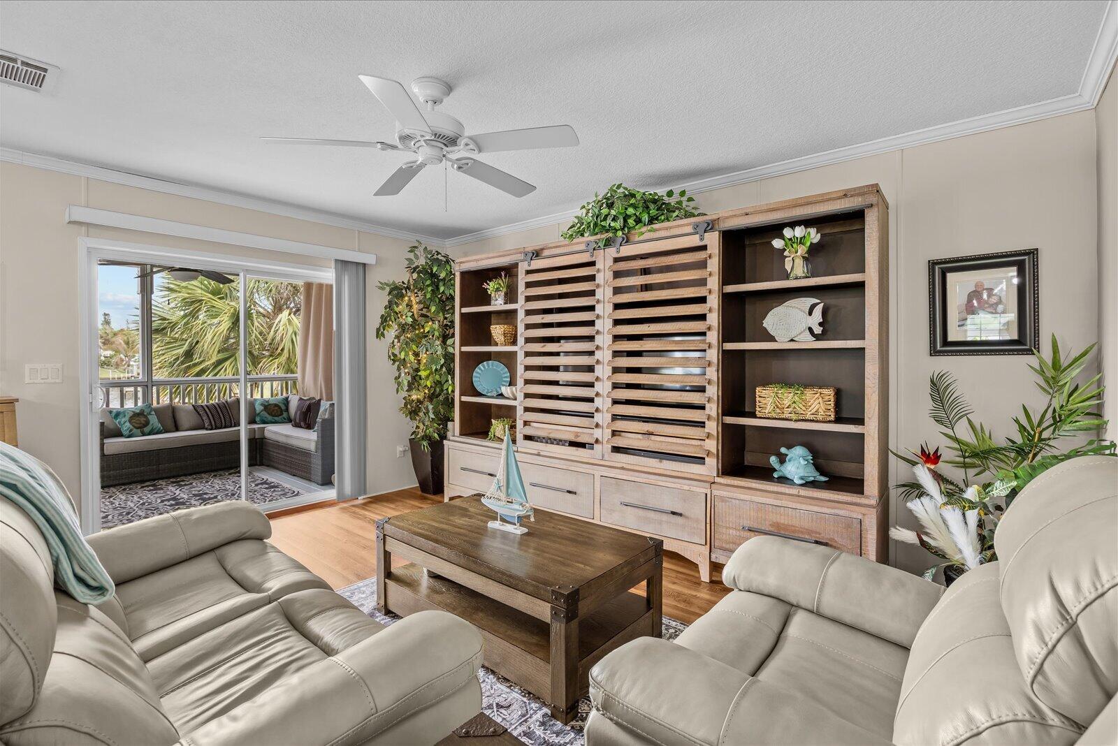 121 Southeast Paradise Place Stuart, FL 34997 - Photo 10 of 33 a living room with furniture and a large window
