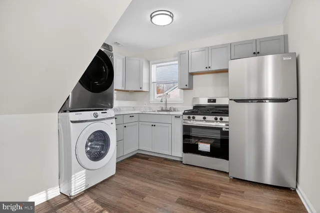 a kitchen with a refrigerator a washer and dryer