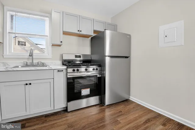 a kitchen with a stove a refrigerator and a sink