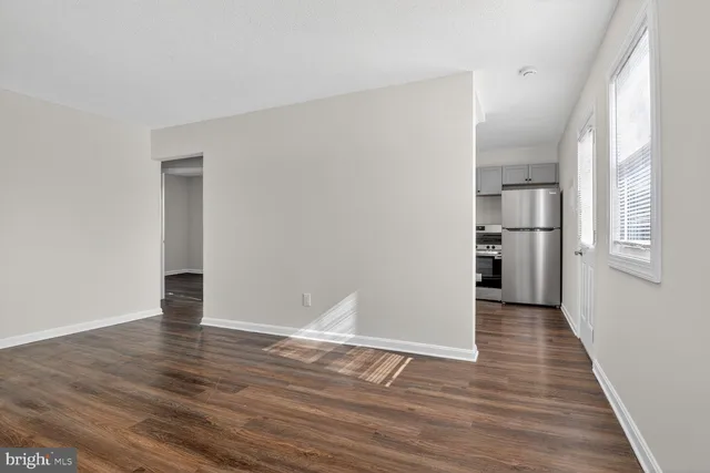 a view of empty room with wooden floor