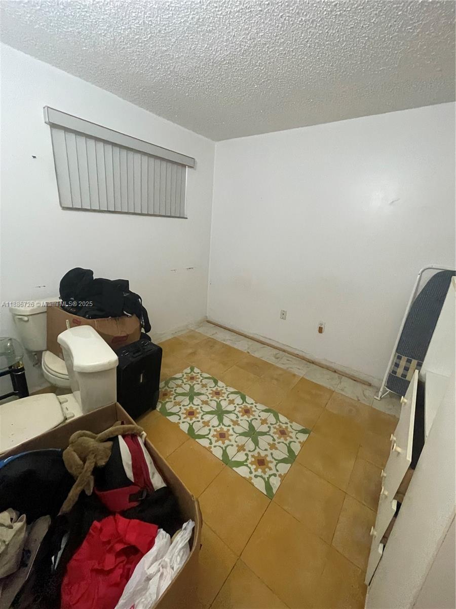 777 Southwest 9th Avenue, Unit 314 Miami, FL 33130 - Photo 5 of 8 a bedroom with a bed and teddy bear on the dresser