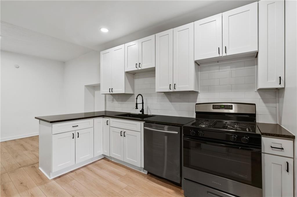 310 5th Avenue Braddock, PA 15104 - Photo 11 of 26 a kitchen with granite countertop white cabinets and appliances