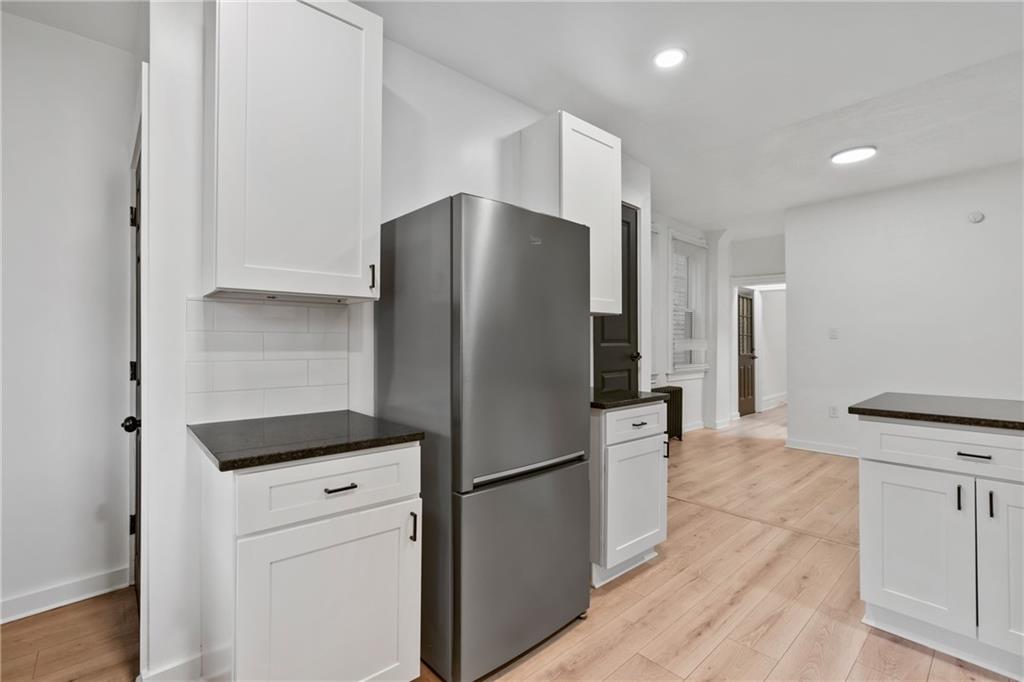 310 5th Avenue Braddock, PA 15104 - Photo 13 of 26 a kitchen with a refrigerator and a stove top oven