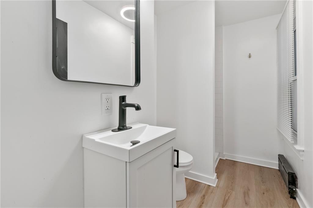 310 5th Avenue Braddock, PA 15104 - Photo 18 of 26 a bathroom with a toilet a sink and mirror