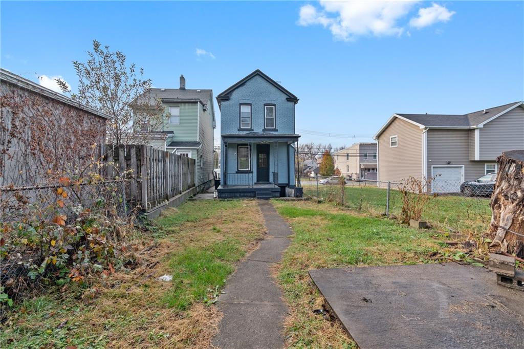 310 5th Avenue Braddock, PA 15104 - Photo 25 of 26 a front view of a house with a yard and large tree