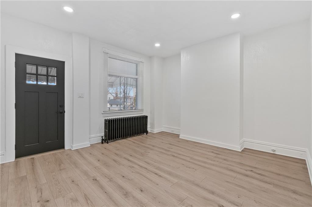 310 5th Avenue Braddock, PA 15104 - Photo 4 of 26 a view of an empty room with wooden floor and a window