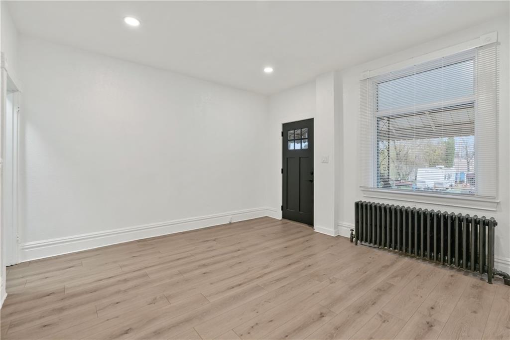 310 5th Avenue Braddock, PA 15104 - Photo 5 of 26 wooden floor in an empty room with a window