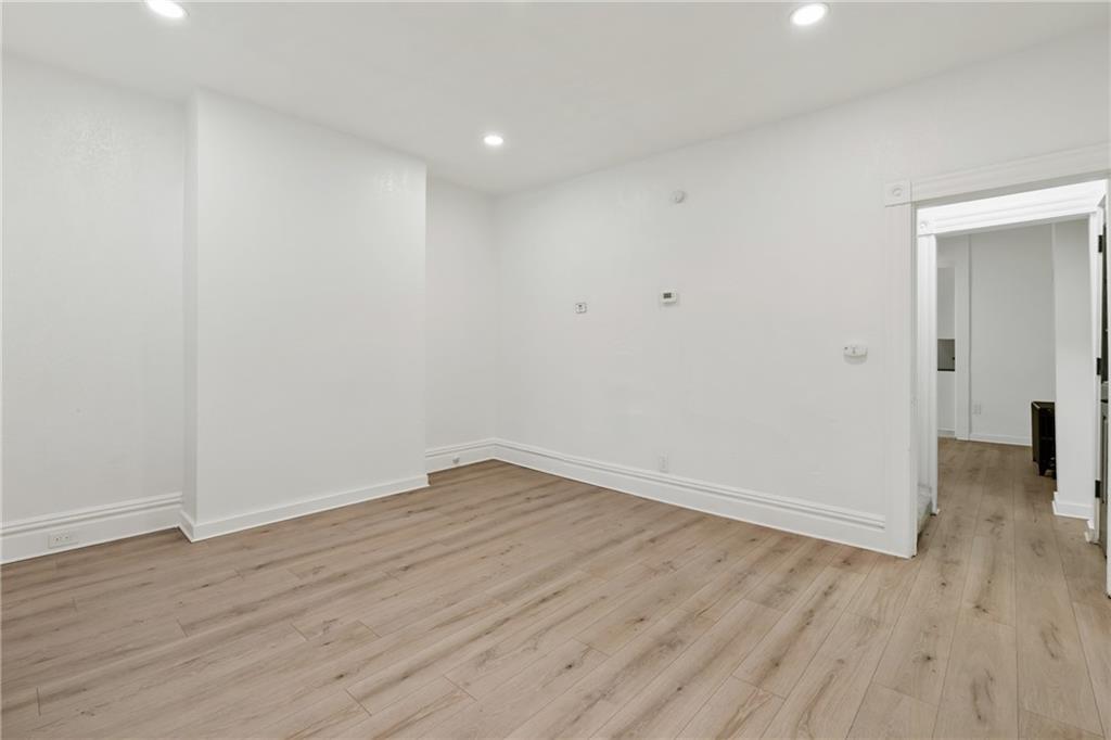310 5th Avenue Braddock, PA 15104 - Photo 6 of 26 a view of an empty room with wooden floor