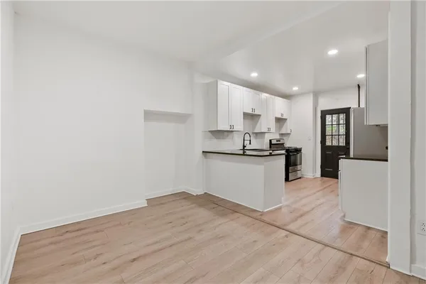 a kitchen with a refrigerator and a stove top oven