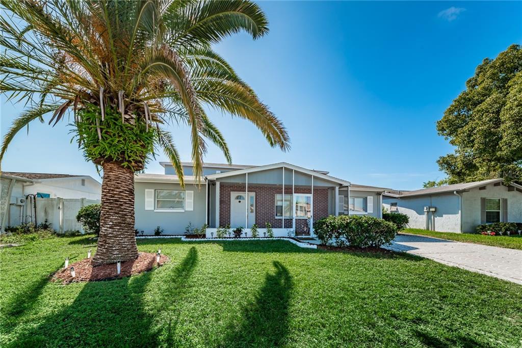 a front view of house with yard and green space