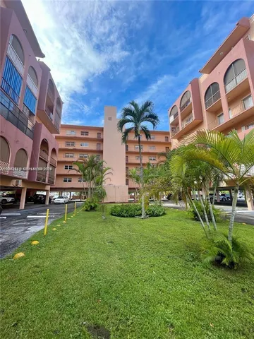 a view of a building with a yard