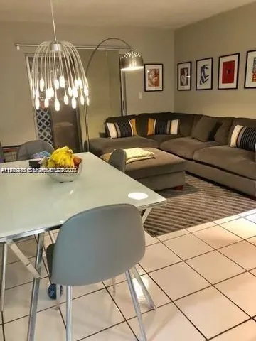 a living room with furniture and painting on the wall