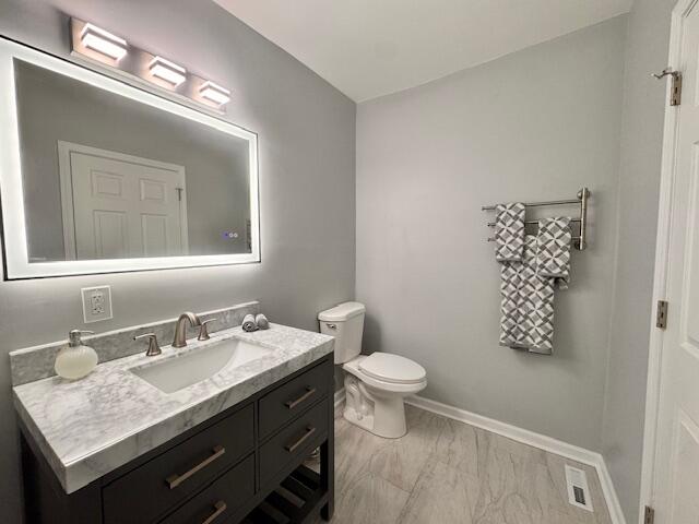 940 Idaho Street Gary, IN 46403 - Photo 19 of 32 a bathroom with a granite countertop sink a toilet and a mirror