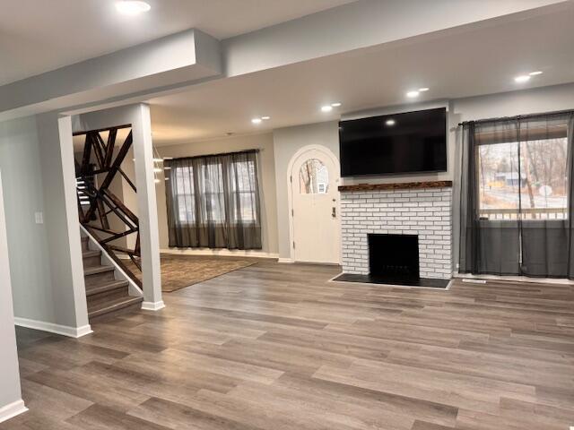 940 Idaho Street Gary, IN 46403 - Photo 2 of 32 an empty room with wooden floor fireplace and windows