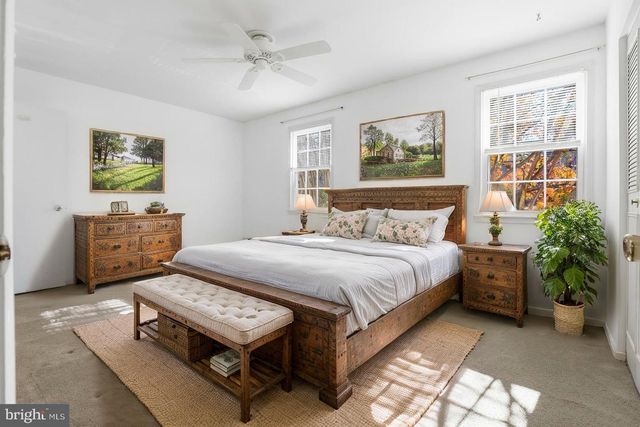 a bedroom with a bed dresser and a window