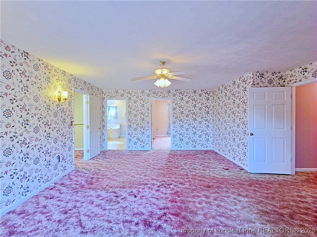 1459 Crawford Wright Road Raeford, NC 28376 - Photo 18 of 50 a bedroom with a bed and a chandelier