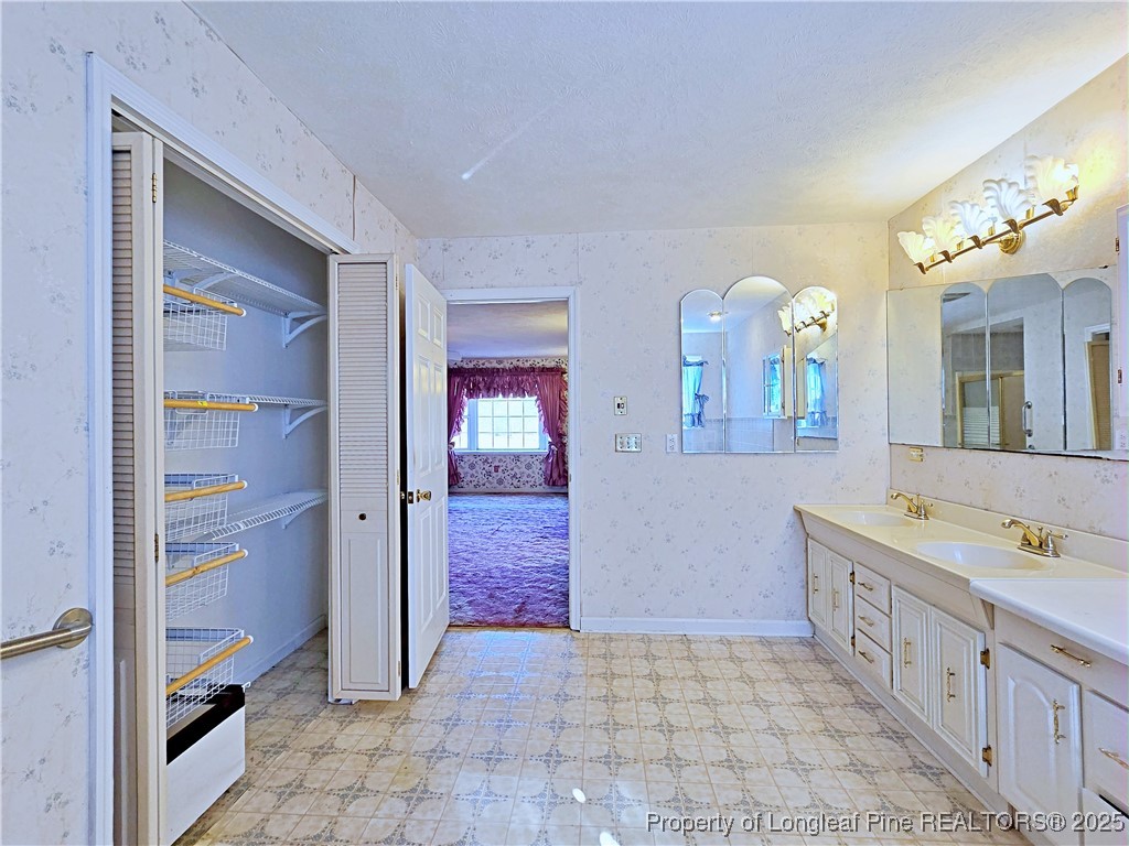 1459 Crawford Wright Road Raeford, NC 28376 - Photo 23 of 50 a bathroom with a sink a mirror and a bathtub