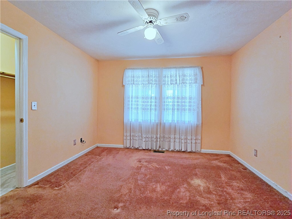 1459 Crawford Wright Road Raeford, NC 28376 - Photo 24 of 50 an empty room with chandelier fan