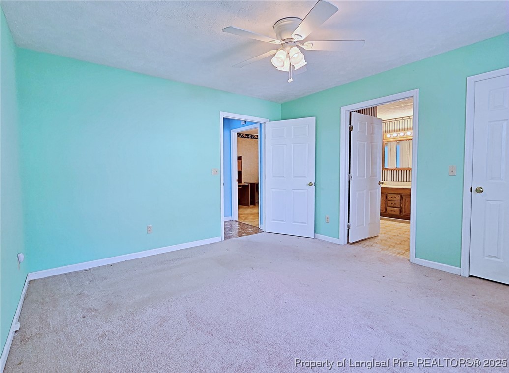 1459 Crawford Wright Road Raeford, NC 28376 - Photo 27 of 50 an empty room with a ceiling fan and a window