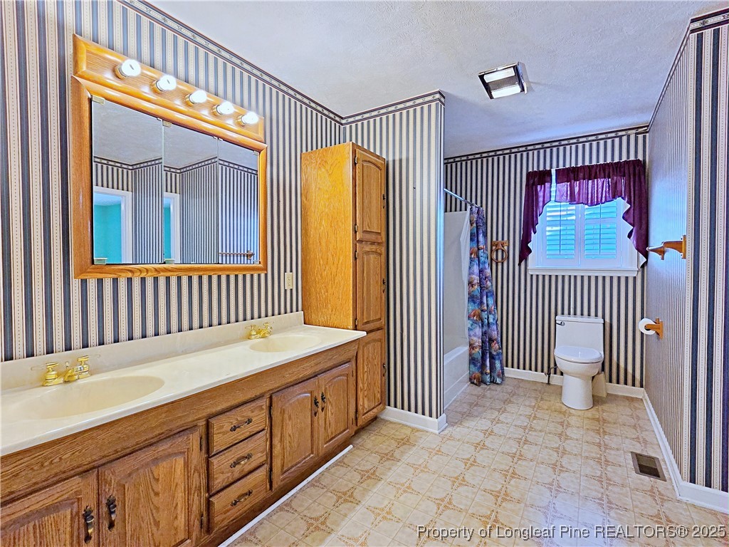 1459 Crawford Wright Road Raeford, NC 28376 - Photo 28 of 50 a bathroom with a sink and a mirror