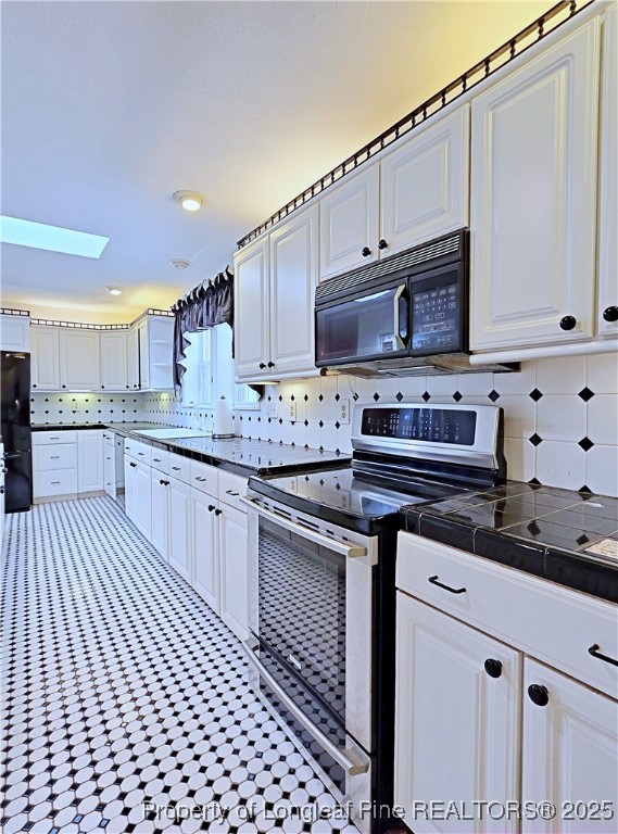 1459 Crawford Wright Road Raeford, NC 28376 - Photo 8 of 50 a kitchen with stainless steel appliances granite countertop a sink stove and cabinets