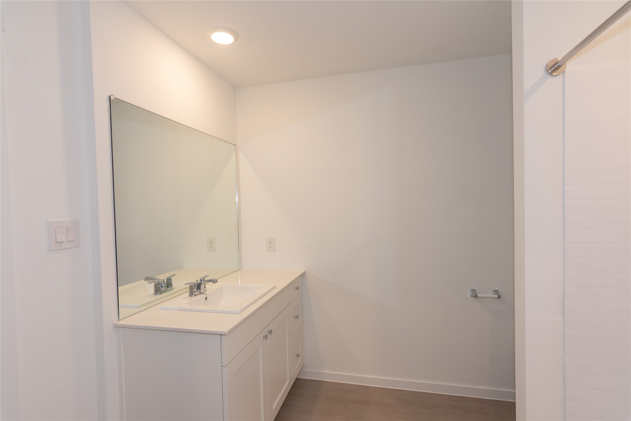 153 Star Packer Lane Jarrell, TX 76537 - Photo 12 of 30 A well-lit bathroom vanity with an integrated sink and spacious mirror.