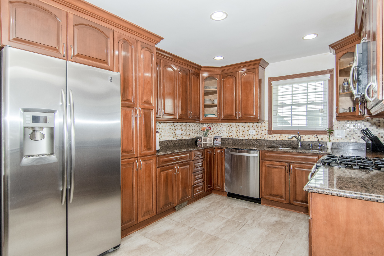1144 Needham Road Naperville, IL 60563 - Photo 13 of 52 a kitchen with stainless steel appliances granite countertop a refrigerator sink and cabinets