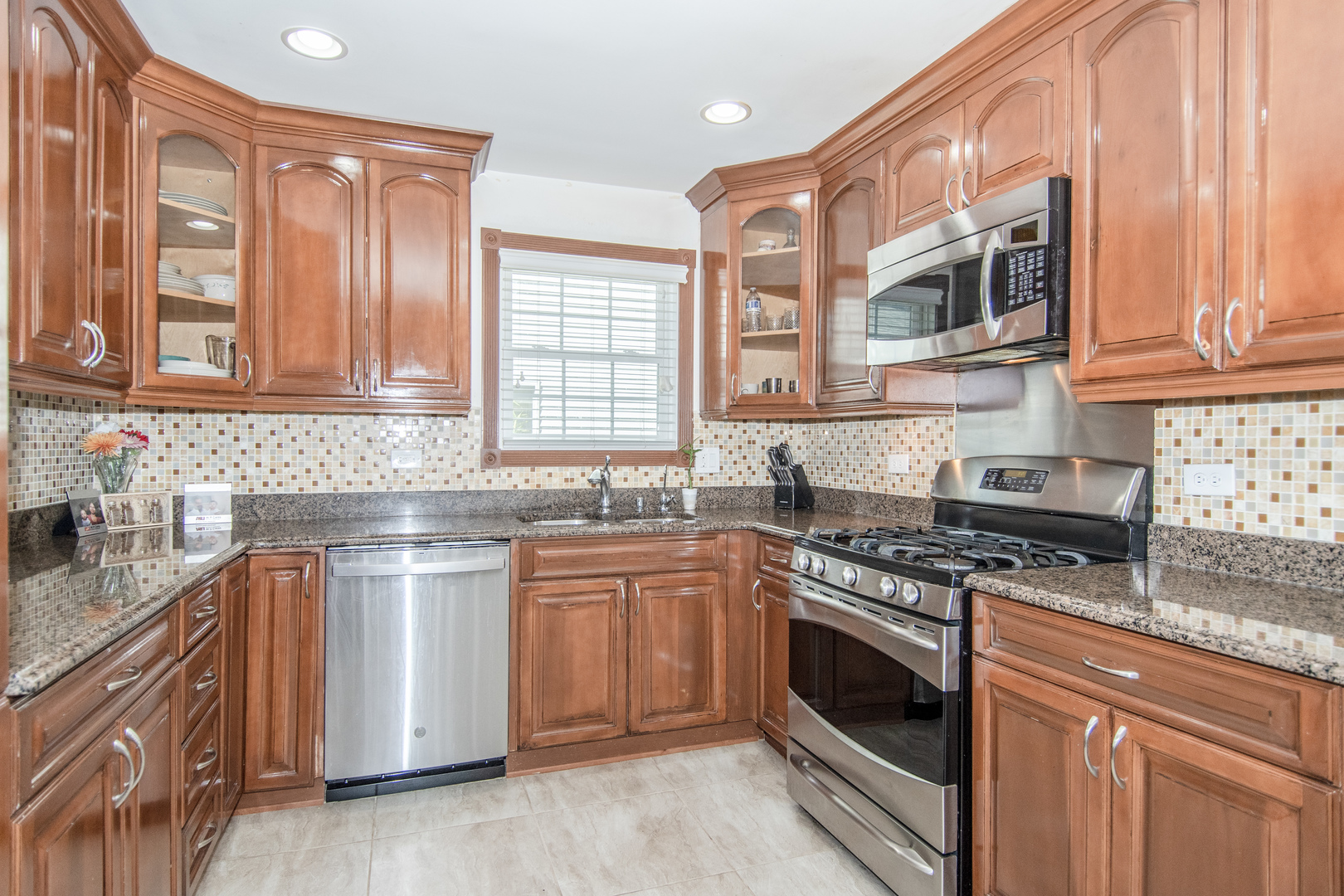 1144 Needham Road Naperville, IL 60563 - Photo 14 of 52 a kitchen with stainless steel appliances granite countertop a stove and cabinets