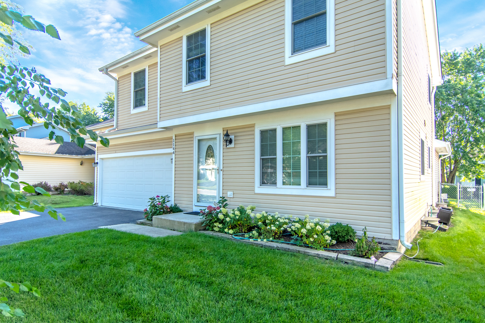 1144 Needham Road Naperville, IL 60563 - Photo 2 of 52 a front view of a house with garden and plants