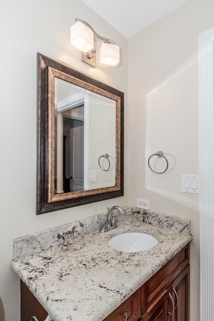 1144 Needham Road Naperville, IL 60563 - Photo 34 of 52 a bathroom with a granite countertop sink and a mirror