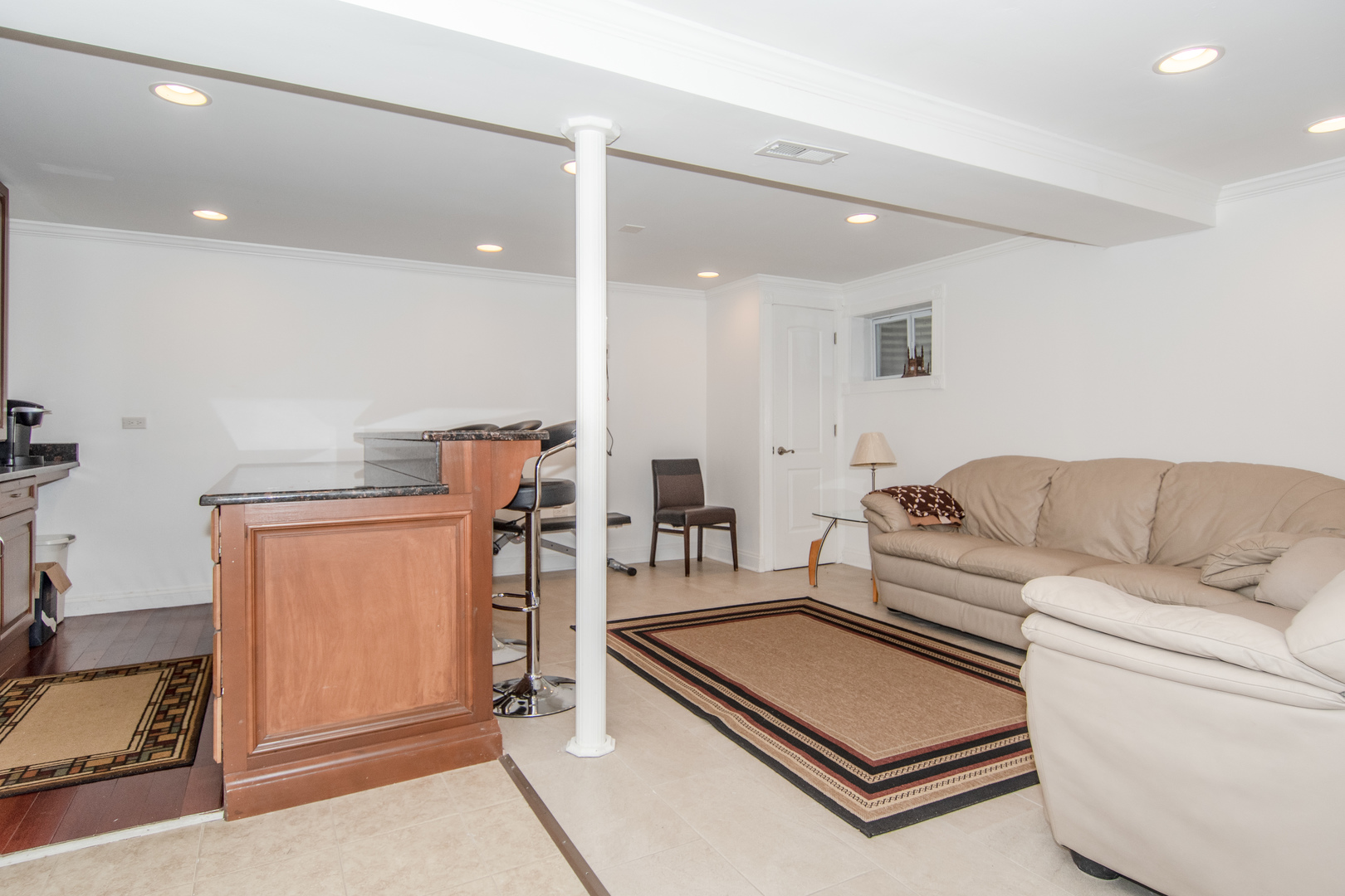 1144 Needham Road Naperville, IL 60563 - Photo 40 of 52 a living room with furniture and a refrigerator
