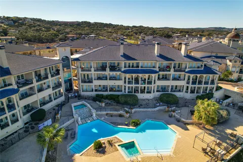 an aerial view of a house with outdoor space and lake view