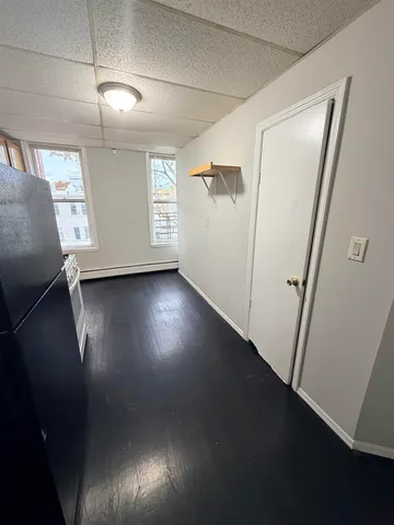 a view of a livingroom with wooden floor and window