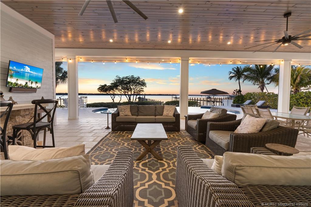 1912 Northwest Cove Circle Stuart, FL 34994 - Photo 1 of 24 a outdoor living space with furniture and a flat screen tv