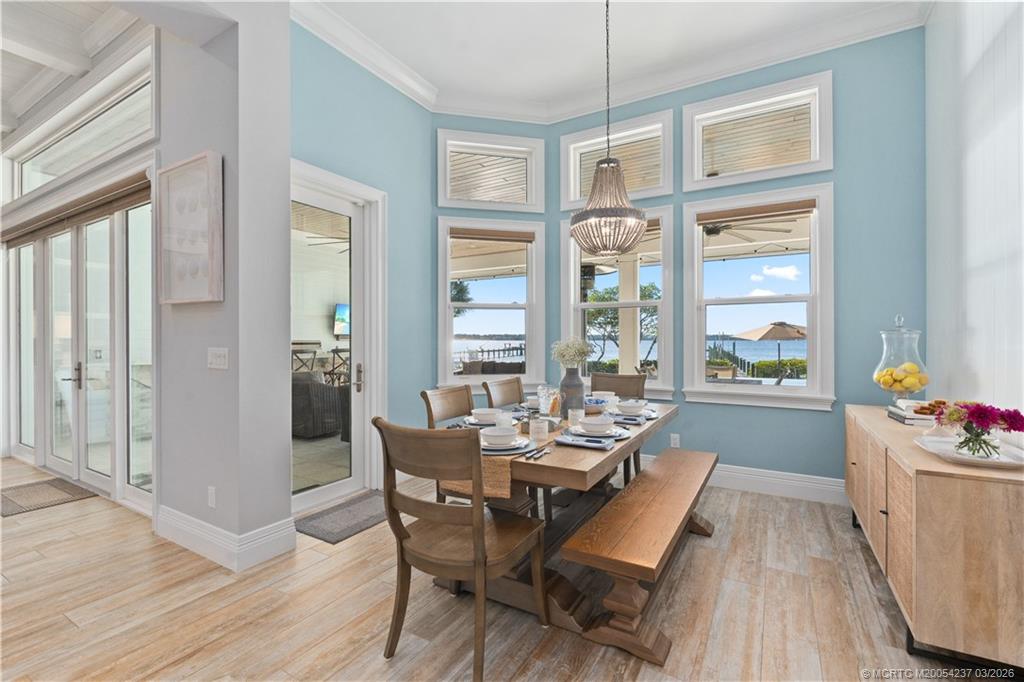 1912 Northwest Cove Circle Stuart, FL 34994 - Photo 11 of 24 a dining room with wooden floor and large windows