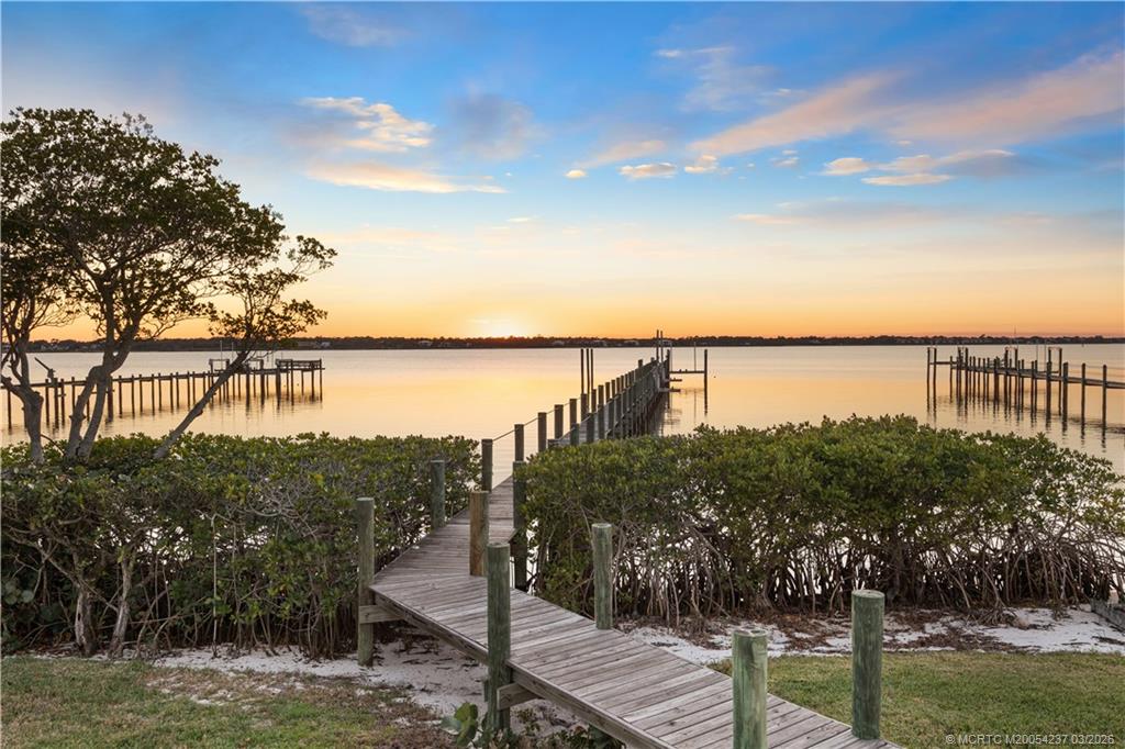 1912 Northwest Cove Circle Stuart, FL 34994 - Photo 16 of 24 a view of a lake with a mountain in the background