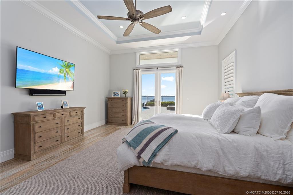 1912 Northwest Cove Circle Stuart, FL 34994 - Photo 17 of 24 a bedroom with furniture and flat screen tv