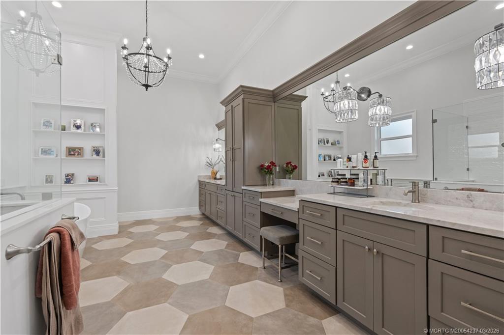 1912 Northwest Cove Circle Stuart, FL 34994 - Photo 18 of 24 a spacious bathroom with a granite countertop sink a mirror a vanity and a shower